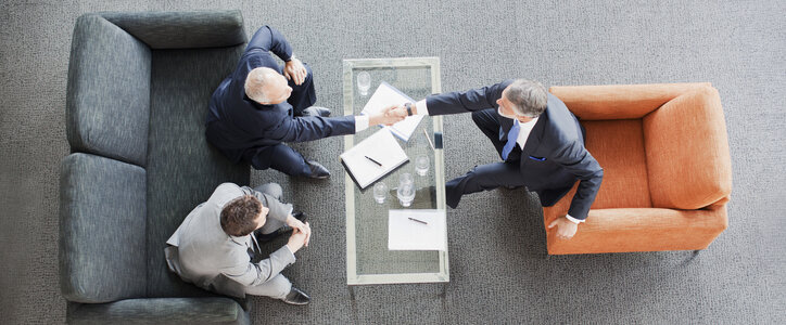 Businessmen shaking hands after the sale of their business.