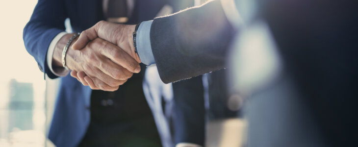 Businessmen shaking hands after a deal